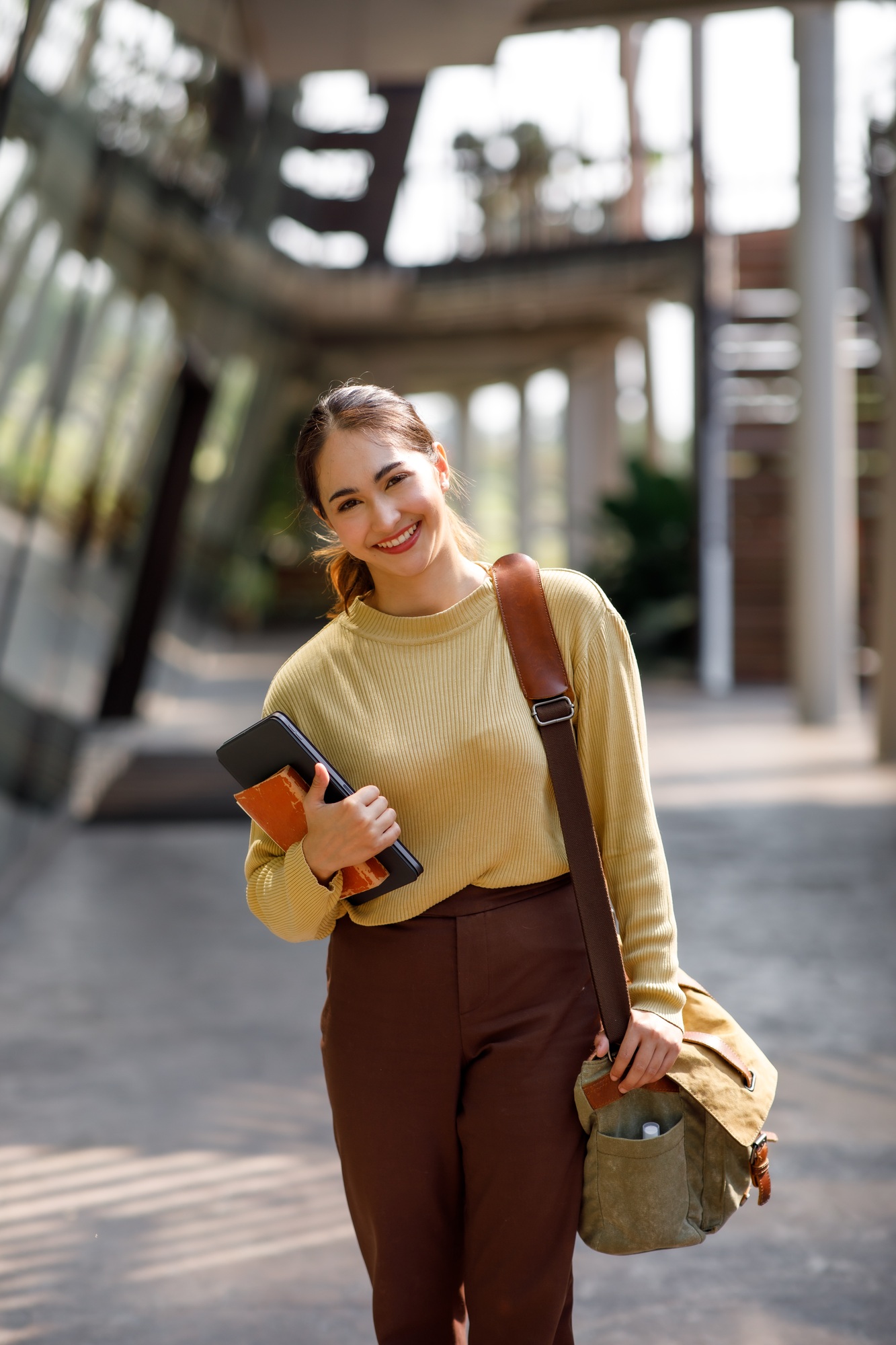Beautiful young Asian woman college student with backpack and tablet books outdoors. College student